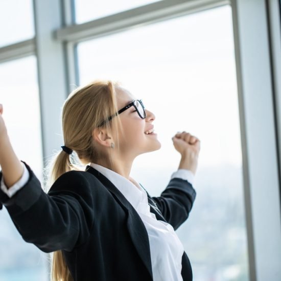 business-woman-excited-hold-hands-up-raised-arms-celebrate-victory-modern-office