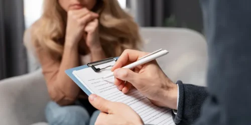 counselor-taking-notes-besides-woman